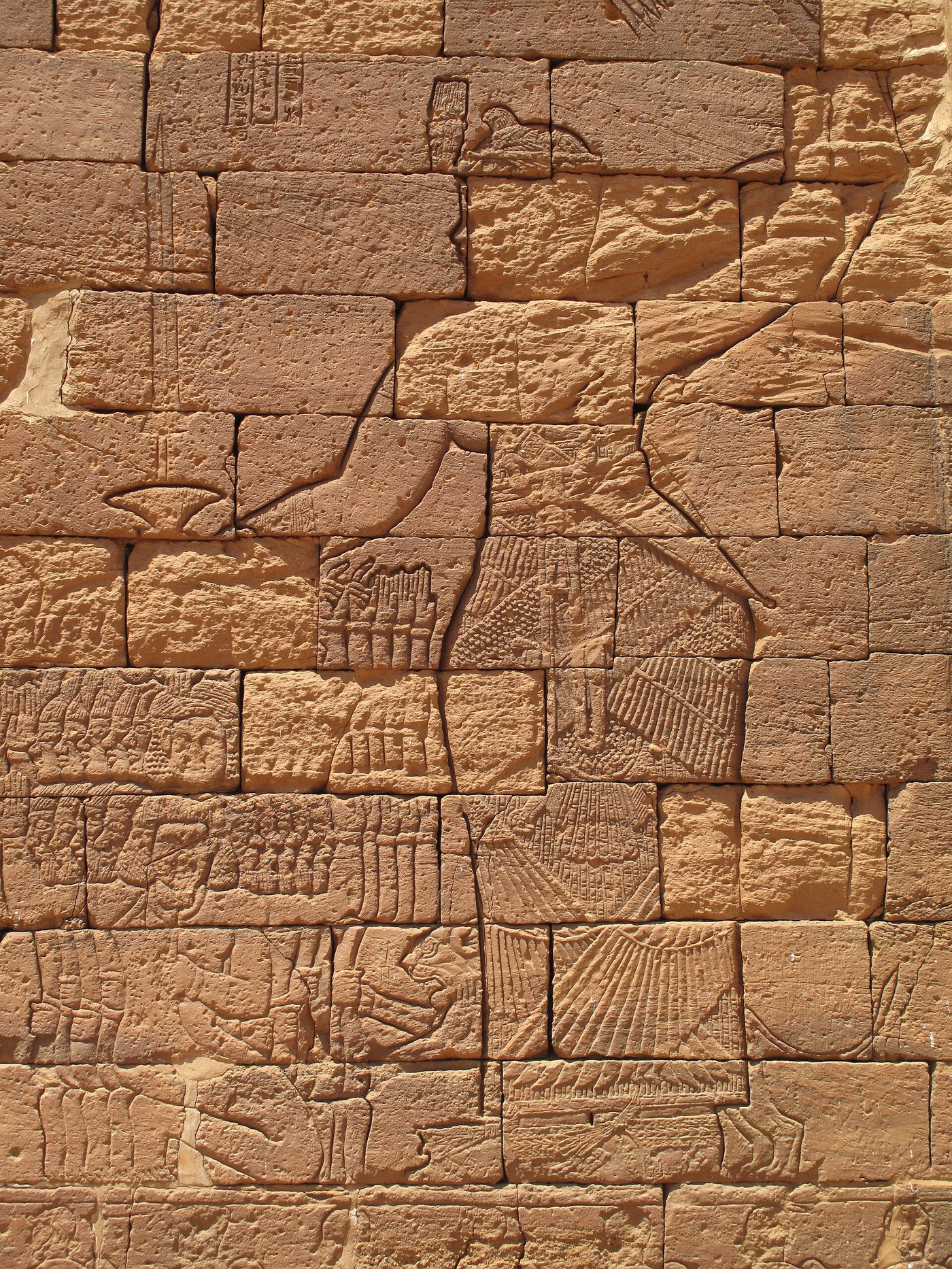 Kushite relief of a queen grasping a handful of captured enemies by the hair