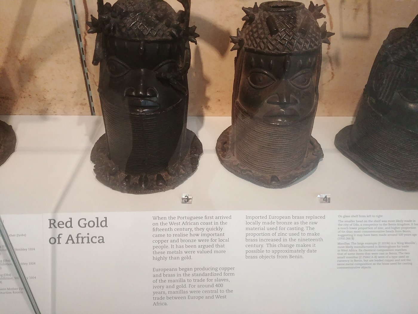 Benin bronzes displayed in a glass case in a Cambridge museum