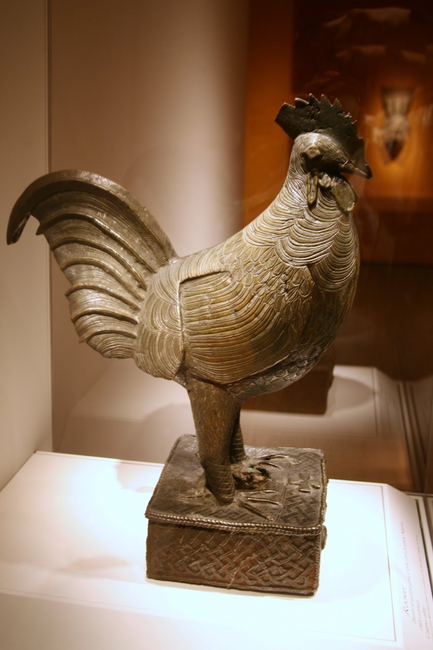 A Benin brass cockerel, an okukor, on display in a museum