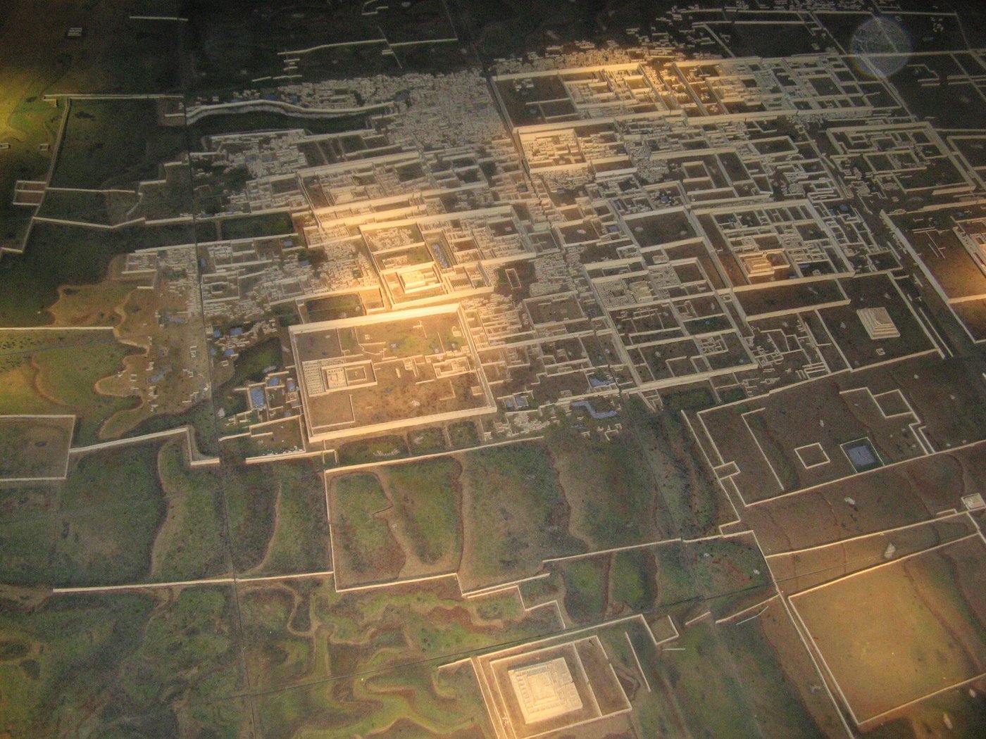 A scale model of Chan Chan showing large rectangular walled compounds packed across flat desert ground
