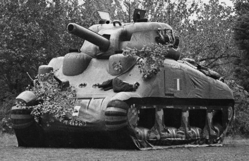 A dummy Sherman tank standing in an open field, used for military deception