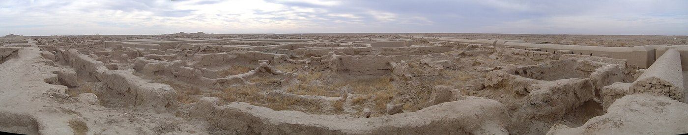 Panorama of the excavated mud-brick ruins of Gonur Depe under a wide desert sky