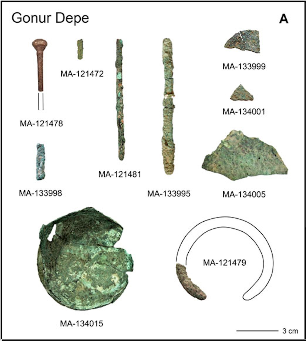 A group of corroded Bronze Age bronze tools and implements excavated at Gonur Depe