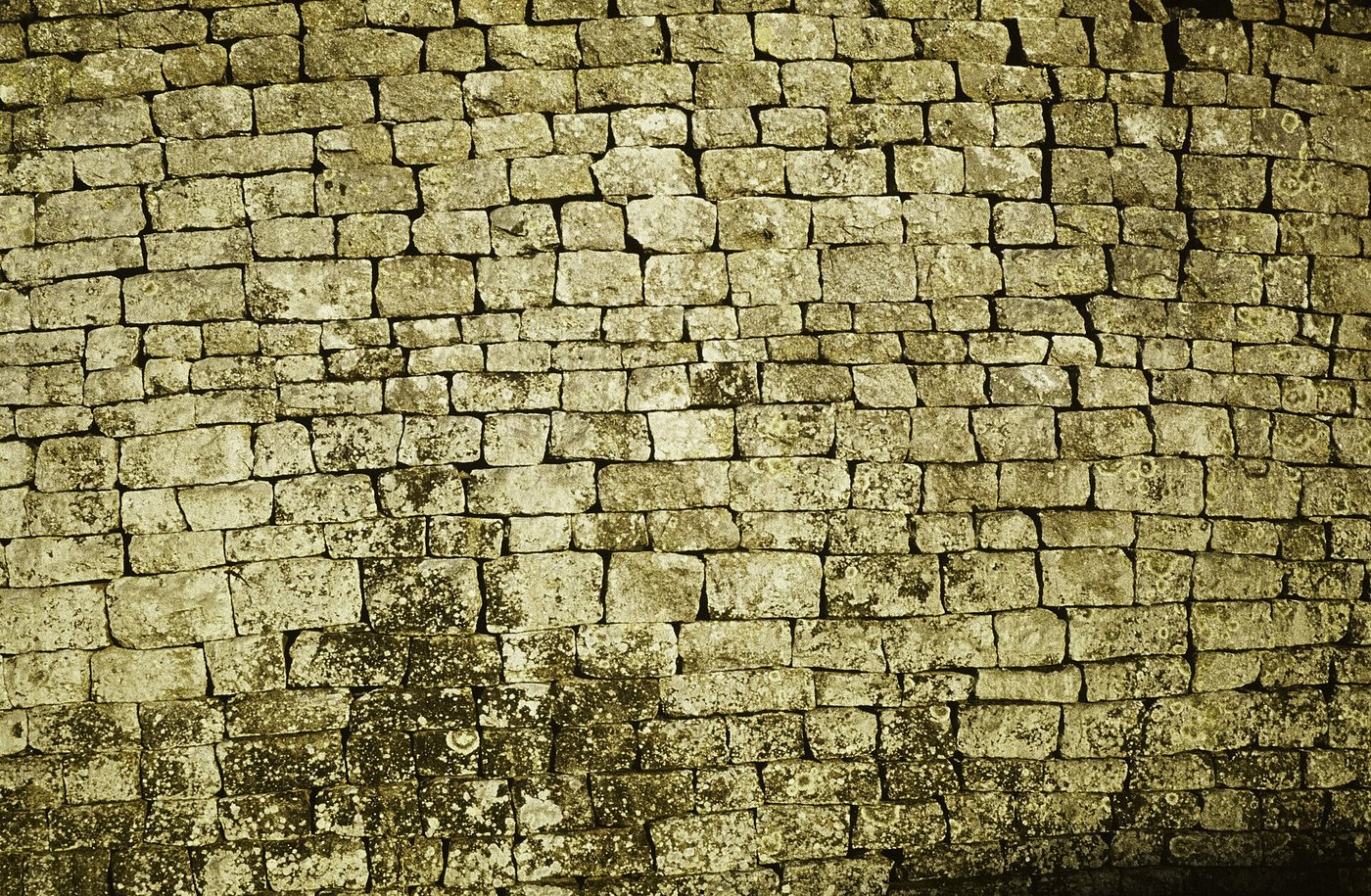 Close view of the coursed granite blocks of a Great Zimbabwe wall, spotted with lichen