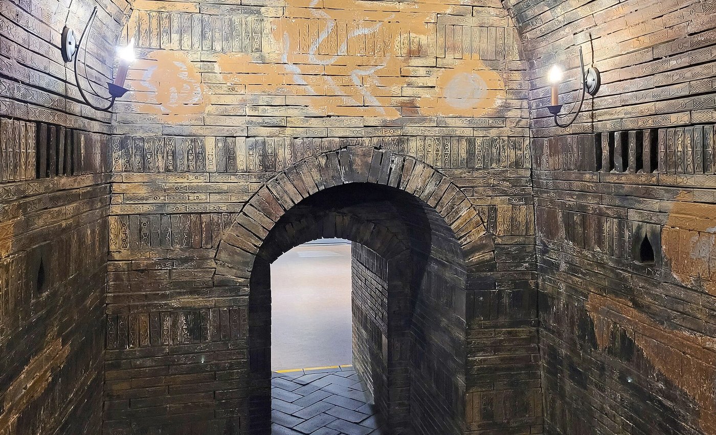 The brick-lined interior of the Tomb of King Muryeong, showing the tunnel-vaulted burial chamber built from patterned grey bricks