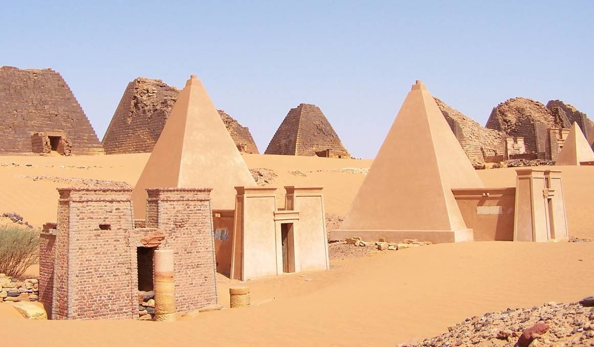 A close-packed row of steep, narrow sandstone pyramids at Meroë in Sudan, several with flattened or broken tops