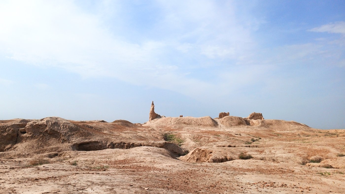Aerial view of the vast mud-brick walls and enclosure of Gyaur Kala at Merv, a great square of eroded ramparts on the desert plain