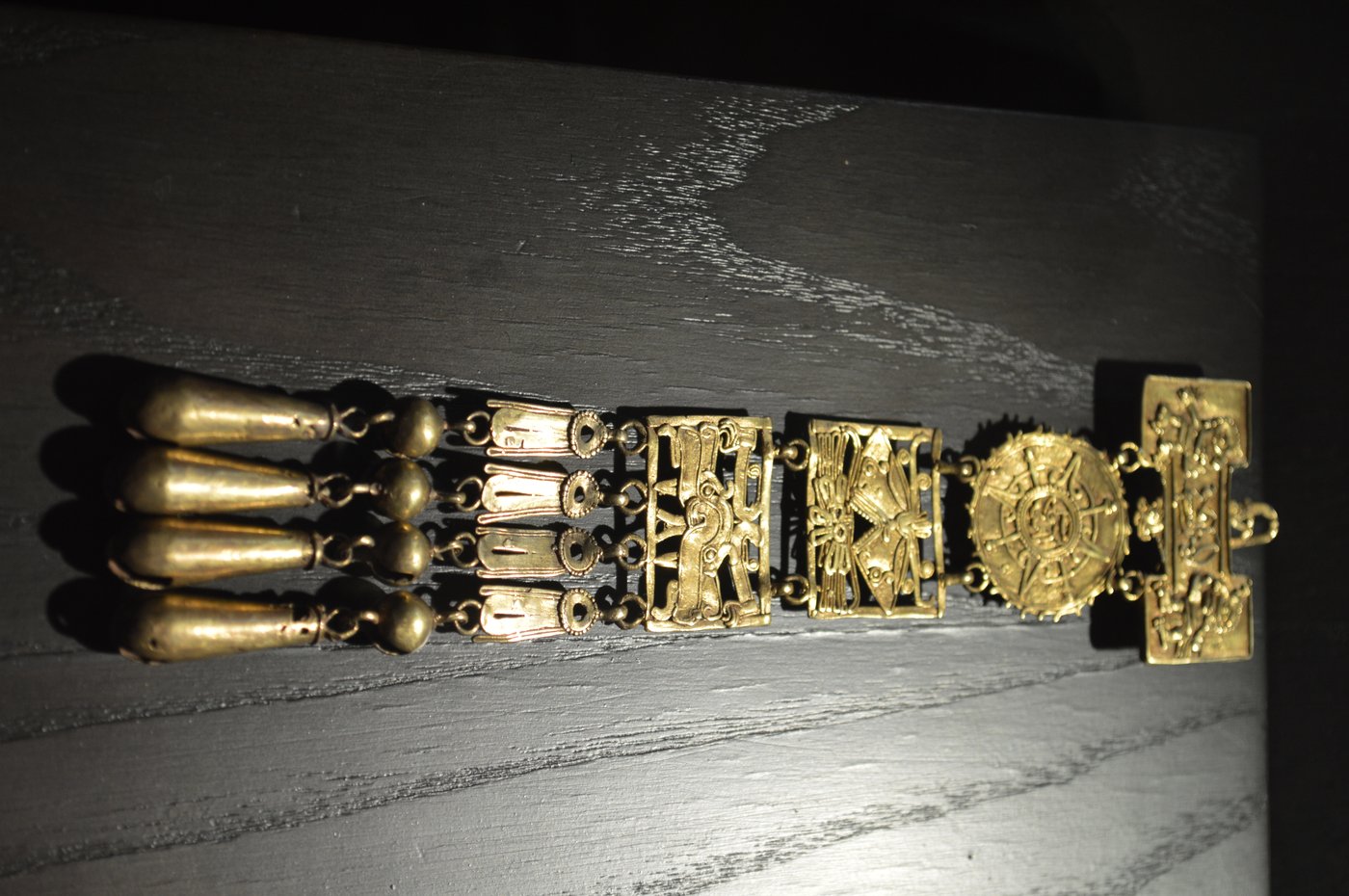 A finely worked gold ornament from Tomb 7 at Monte Albán, on display in a museum case