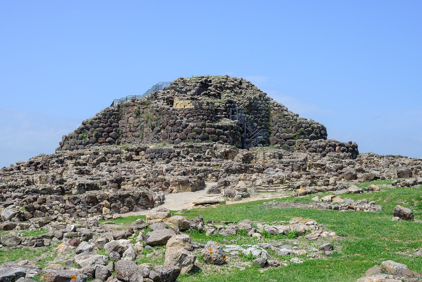The dry-stone nuraghe of Su Nuraxi at Barumini, Sardinia, a massive conical tower of unmortared basalt blocks with the remains of a surrounding village