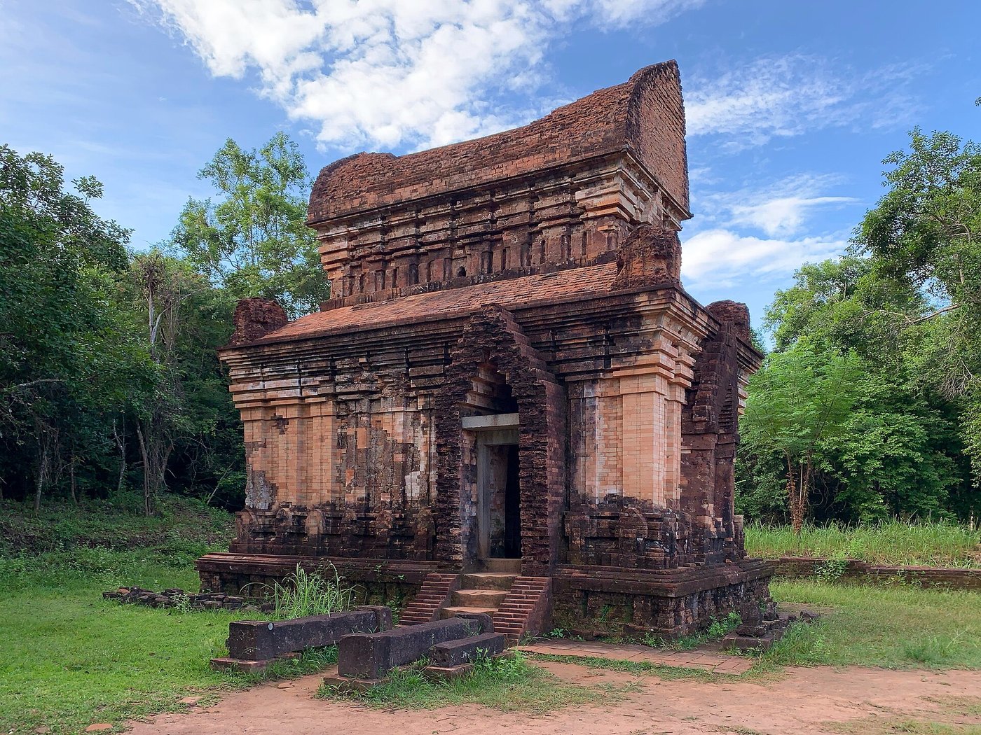 A well-preserved brick Cham temple tower at My Son with a tiered roof and a carved false doorway