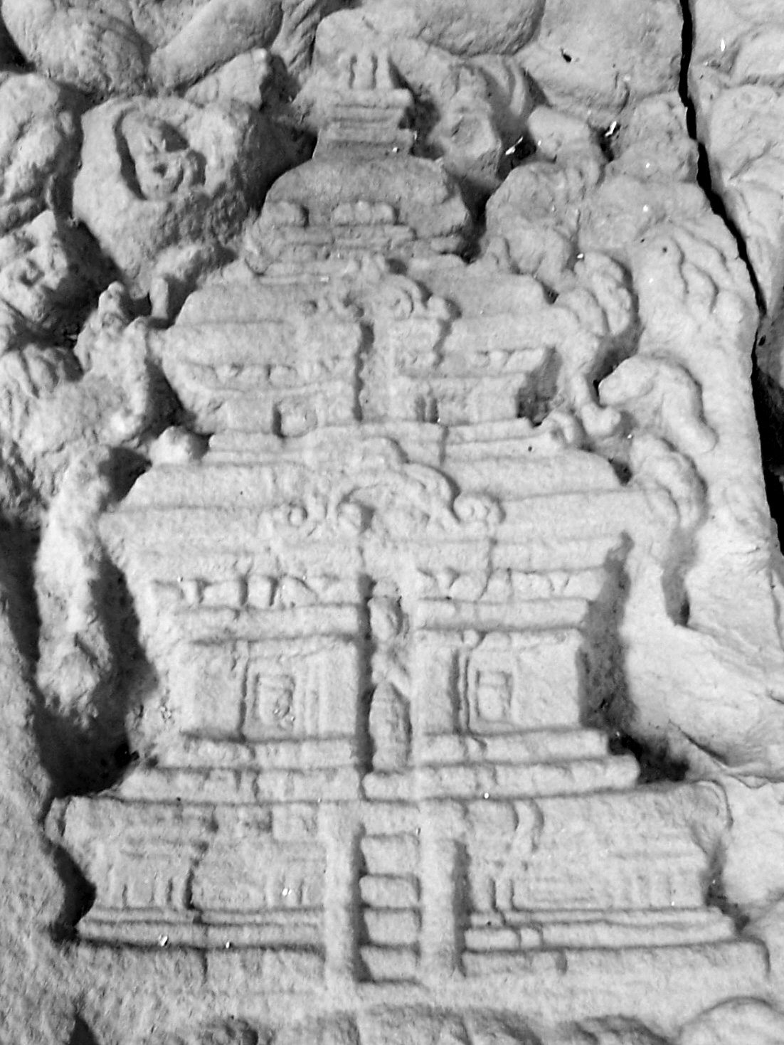 Weathered carved brickwork on a My Son tower, foliage patterns and figures cut directly into the wall