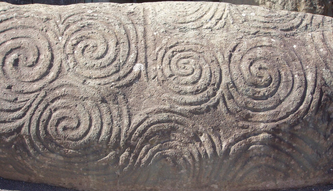 The carved entrance stone K1 at Newgrange, its surface covered with interlocking triple spirals, lozenges and coils
