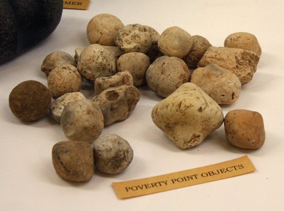 A group of baked clay Poverty Point Objects of different shapes, the fired-clay balls used for cooking in earth ovens