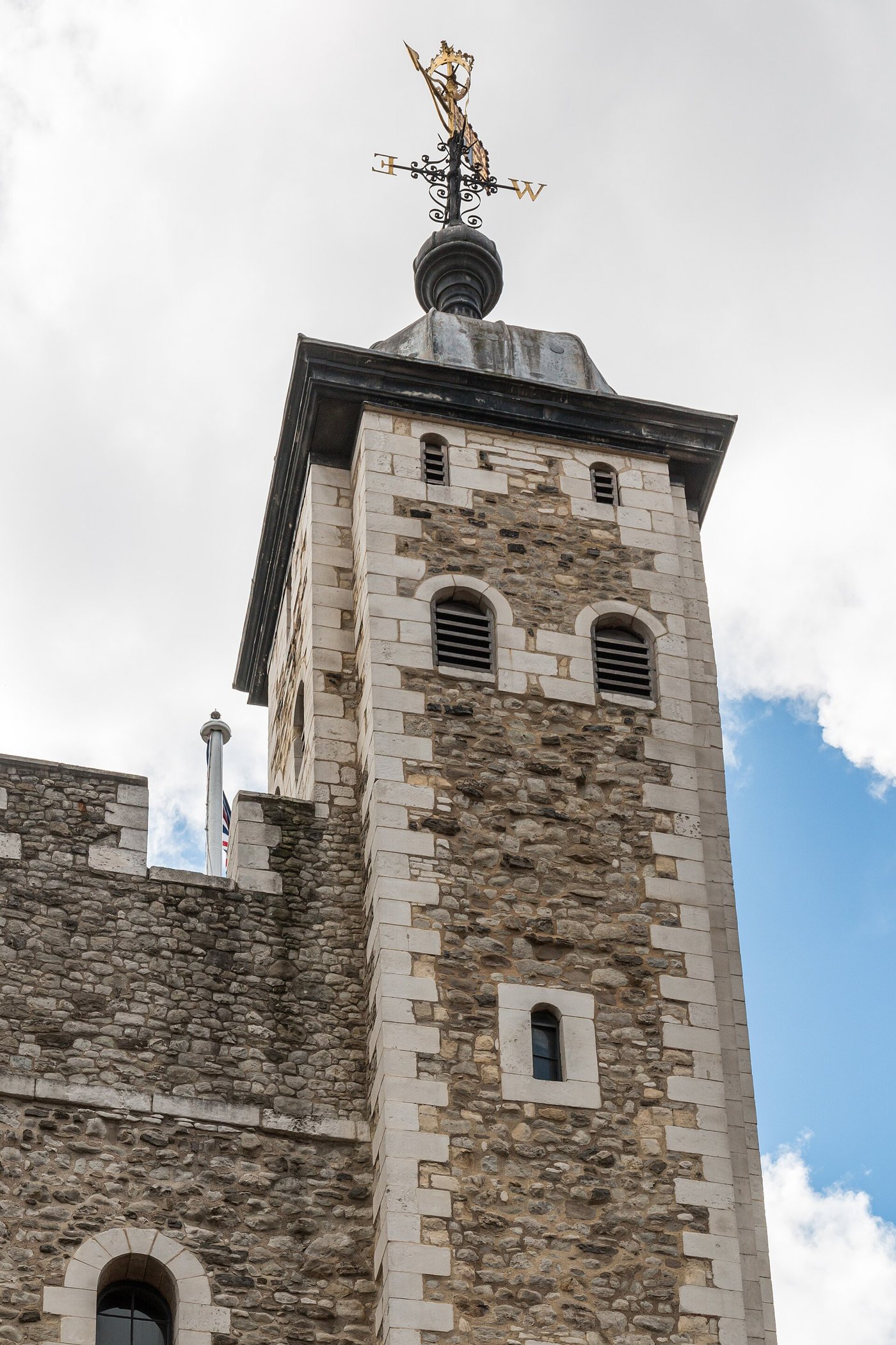 The White Tower at the centre of the Tower of London, a pale stone keep against a blue sky