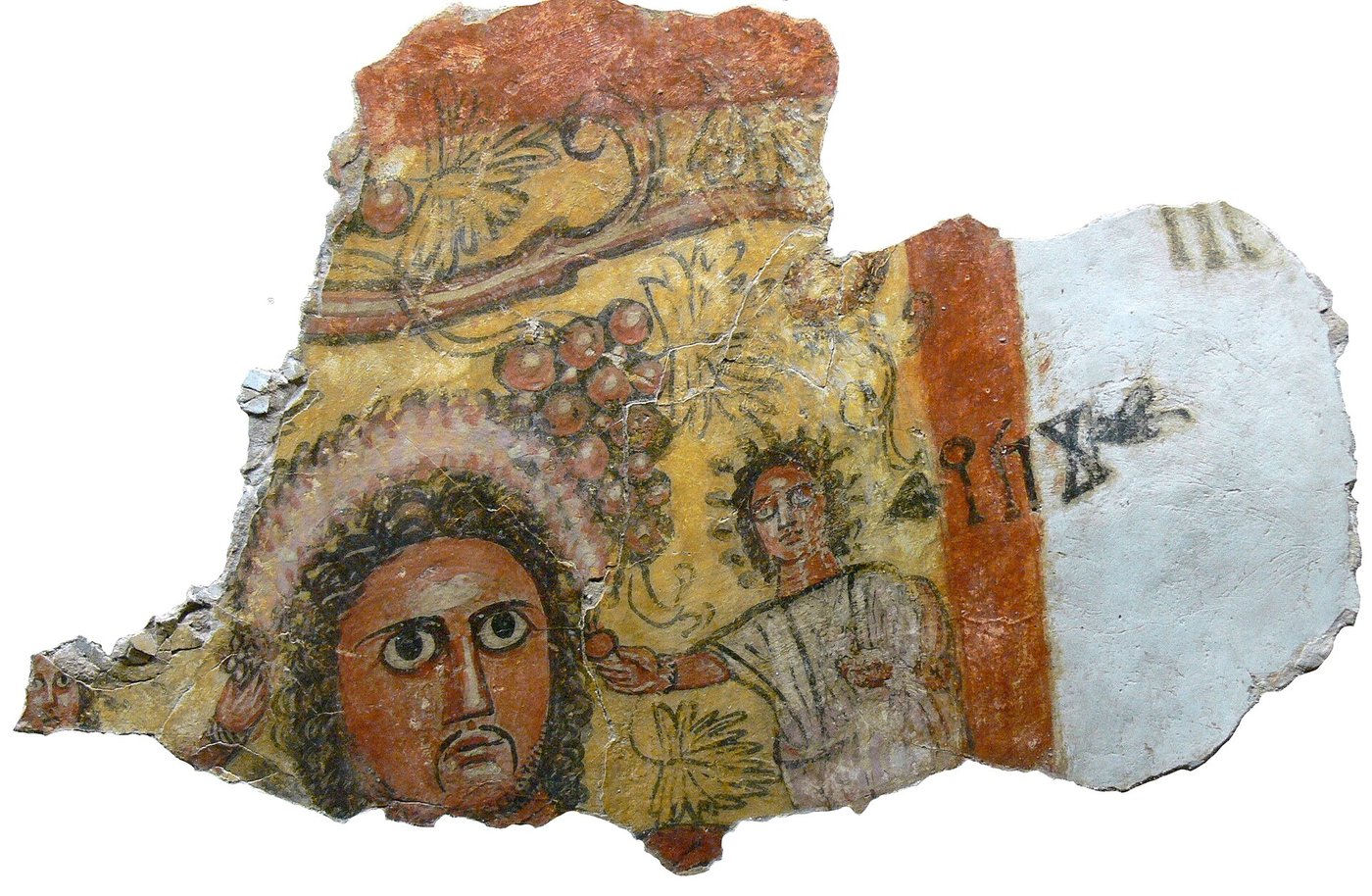 A fragment of a painted mural from Qaryat al-Faw showing part of a human figure, with an Ancient South Arabian inscription reading zky