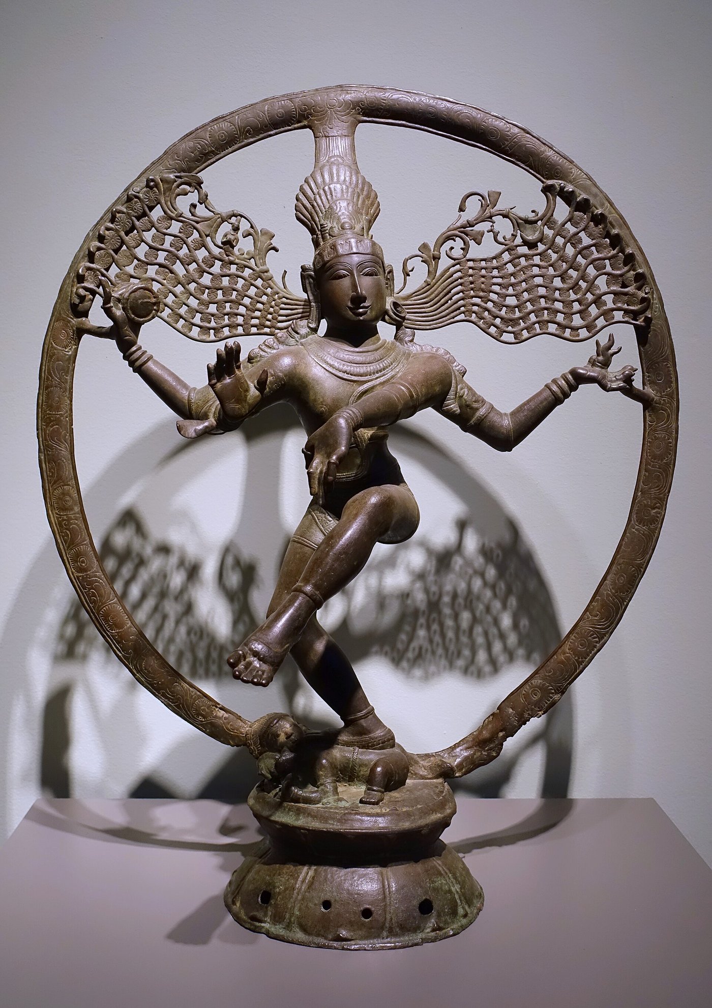 A Chola-era bronze statue of Shiva as Nataraja, the lord of dance, ringed by a circle of flame, one foot raised in mid-step