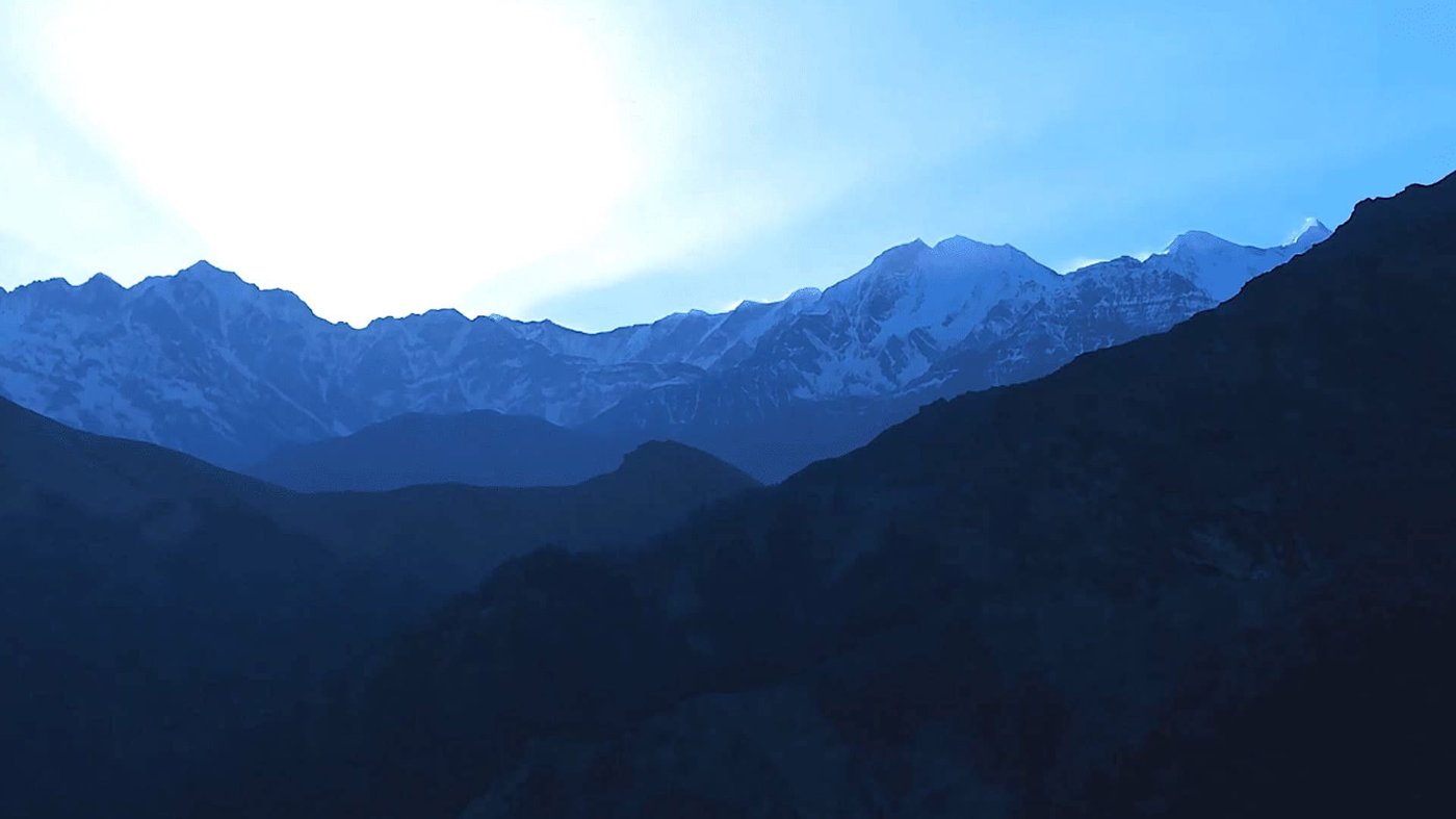 Silhouetted Himalayan mountain ridges at dusk near the Roopkund trekking route