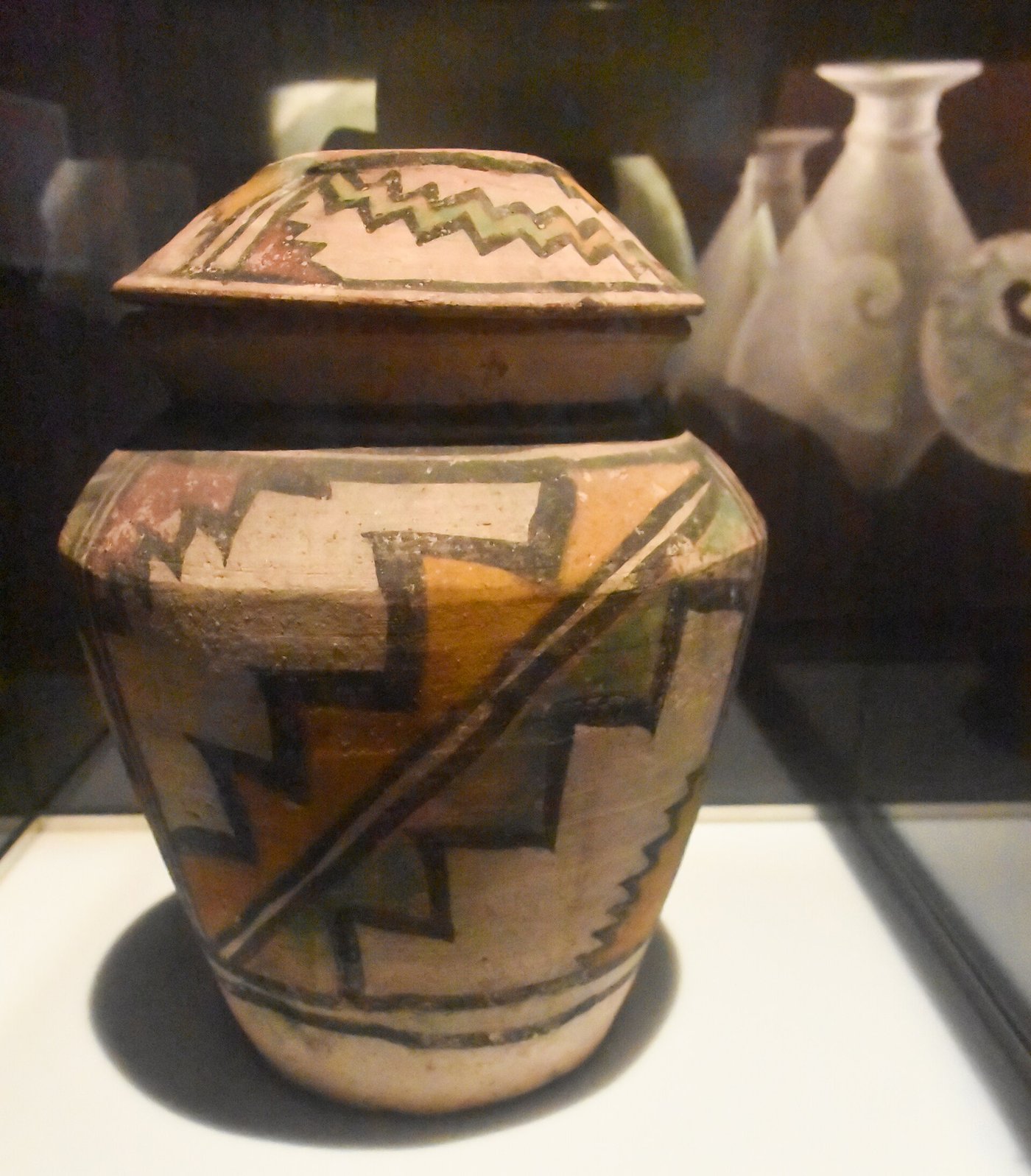 A painted Bronze Age jar from Shahr-e Sukhteh with geometric bands in dark paint on a buff ground.