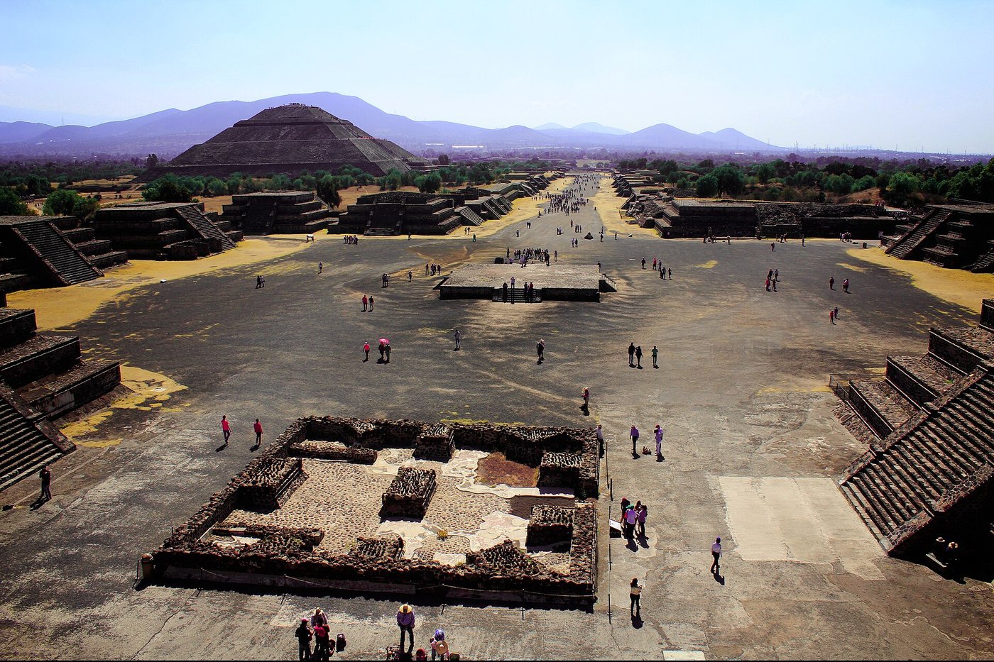 The Avenue of the Dead at Teotihuacan running north towards the Pyramid of the Moon, with ruined temple platforms lining both sides.