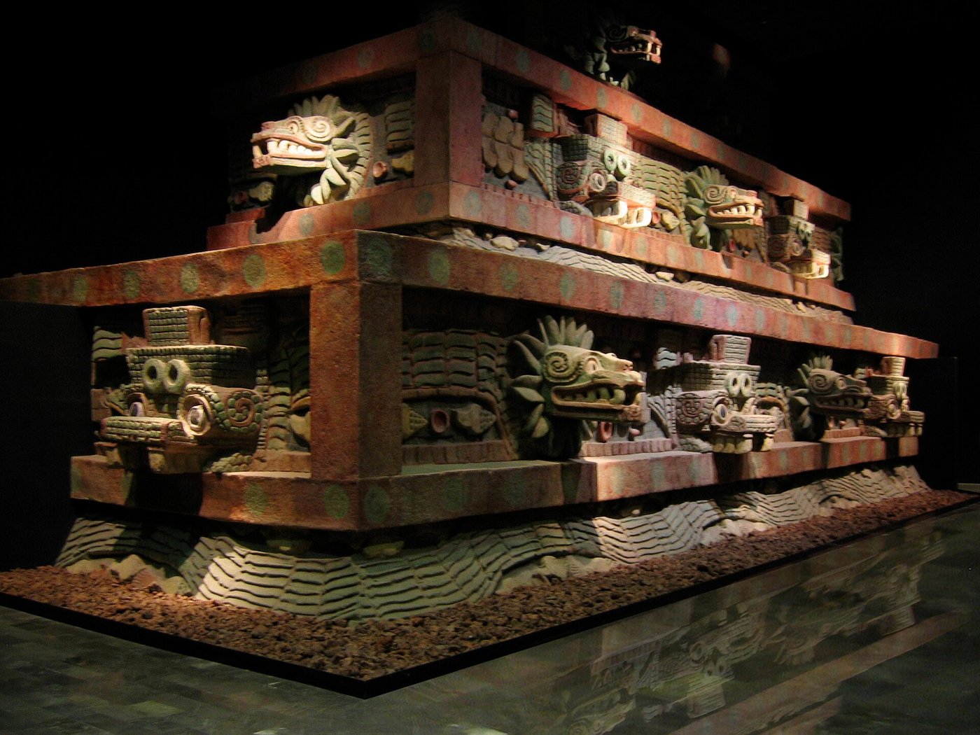 The carved facade of the Temple of the Feathered Serpent at Teotihuacan, with rows of projecting stone serpent heads.