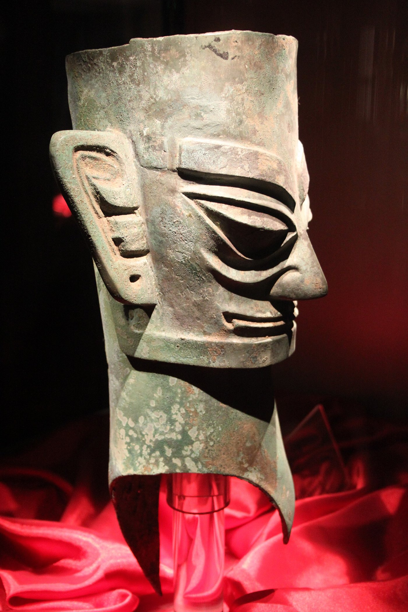 A row of bronze heads from Sanxingdui with angular features and slotted necks