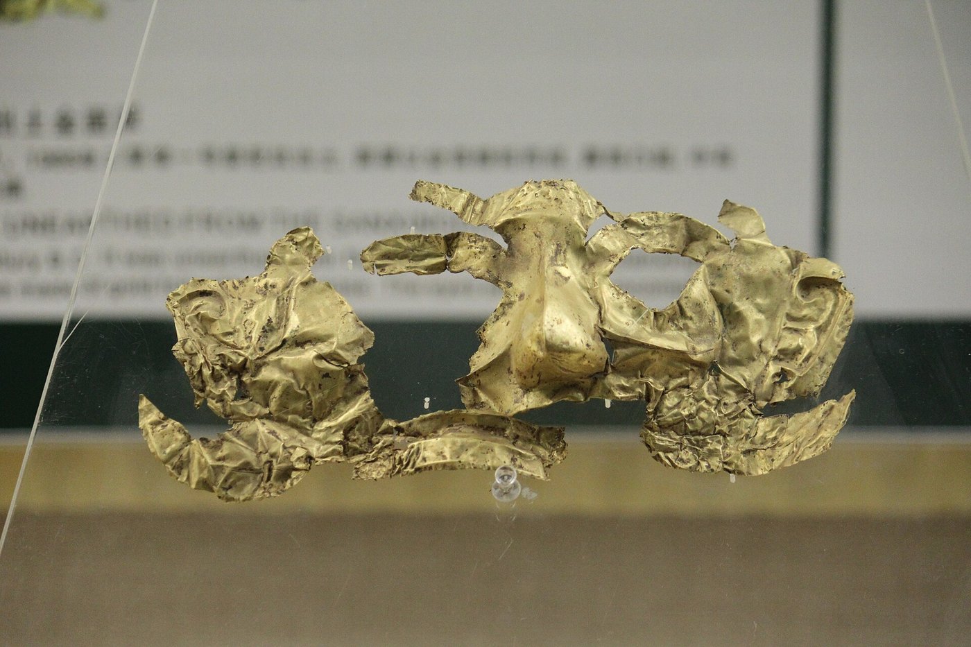 A thin gold mask from Sanxingdui, unfolded to show a stylised human face