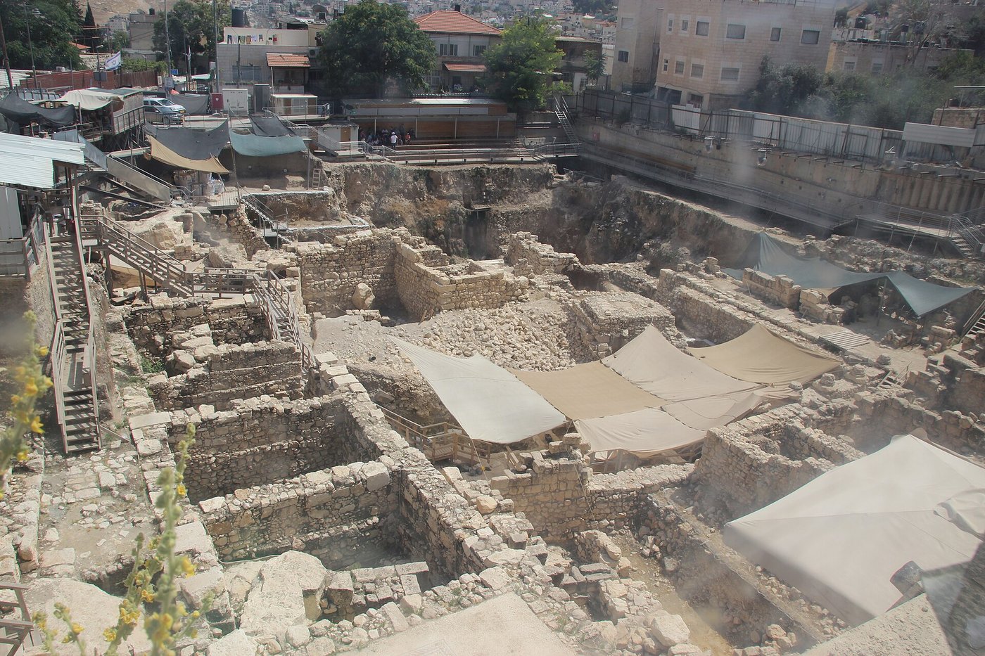Deep archaeological excavation trenches with exposed stone walls from many periods at the Givati Parking Lot site in the City of David, Jerusalem