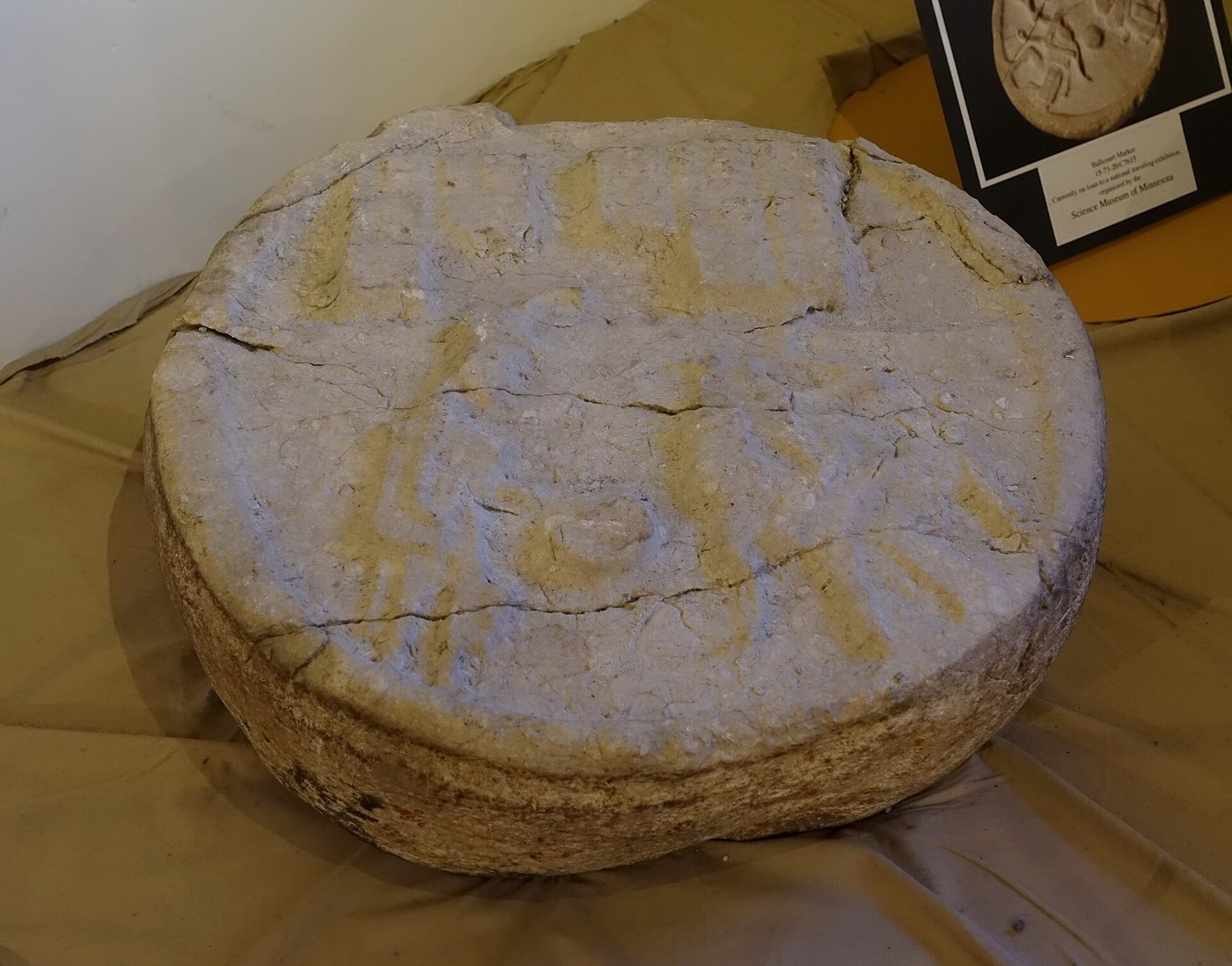 Carved stone ballcourt marker depicting a Maya ballplayer
