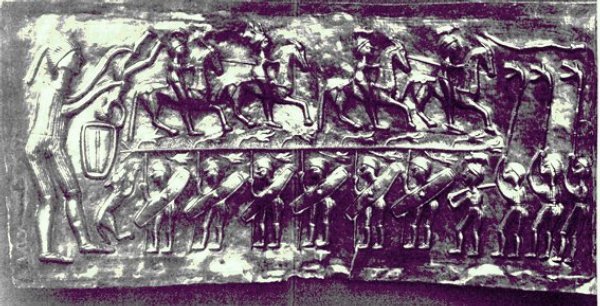 A row of helmeted warriors and, on the far left, a figure holding a tall carnyx upright, embossed on a plate of the Gundestrup cauldron