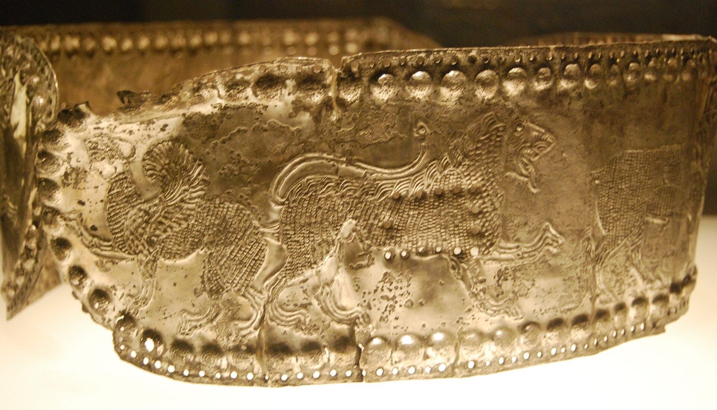 A museum display case filled with ancient Colchian gold ornaments, diadems, necklaces and small animal figures