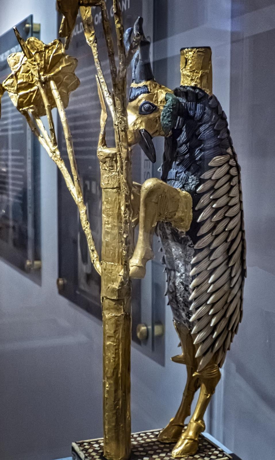 The 'Ram in a Thicket' figure from Ur: a rearing goat in gold, silver, shell and lapis lazuli, its forelegs against a golden flowering tree