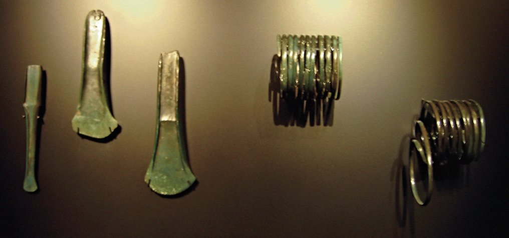 The full Nebra hoard: the disc alongside two bronze swords, axes, a chisel and spiral arm-rings