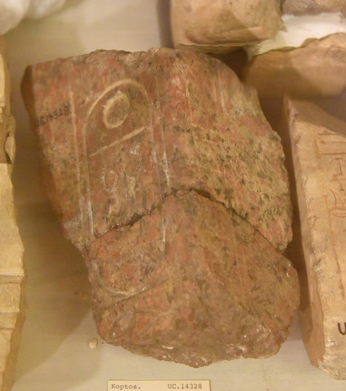A red granite fragment carved with the royal cartouche of Thutmose II