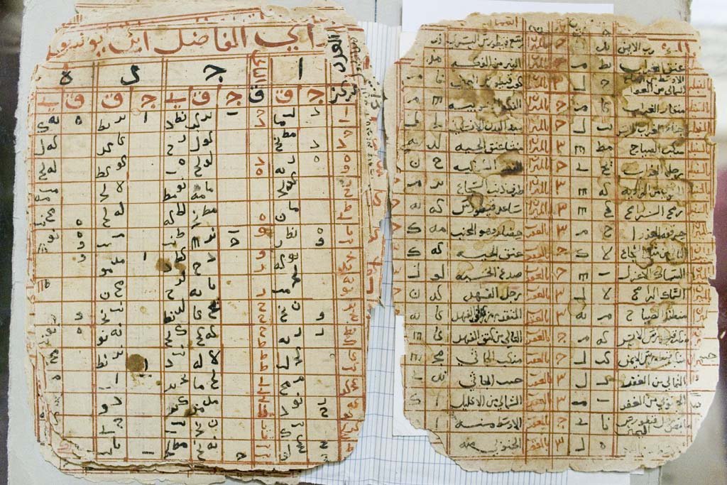 A Timbuktu manuscript page filled with Arabic astronomical tables in red and black ink