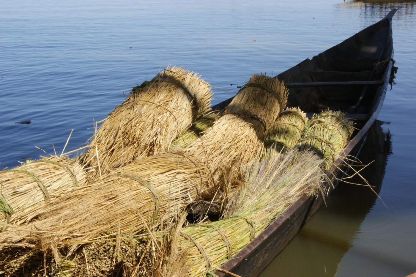 A long wooden pirogue loaded with goods on the Niger River in Mali