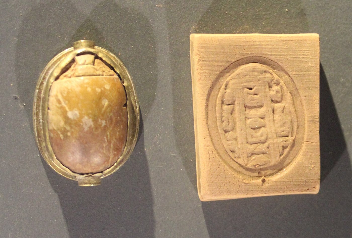 A small gold and faience scarab with hieroglyphs, recovered from the Uluburun shipwreck