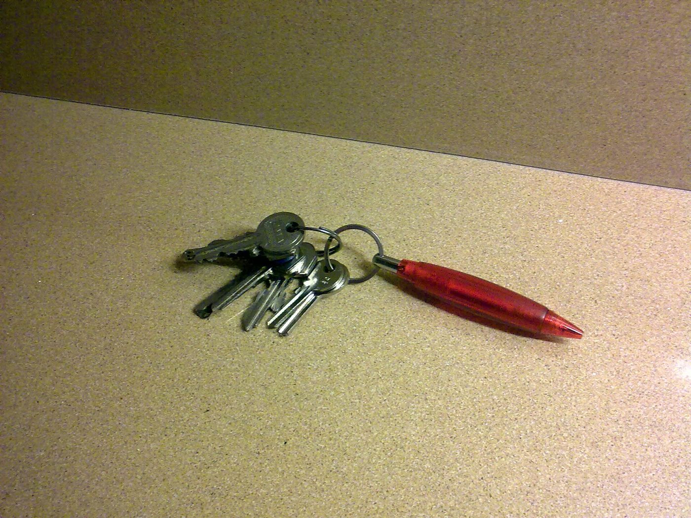 A bunch of house keys on a kitchen counter